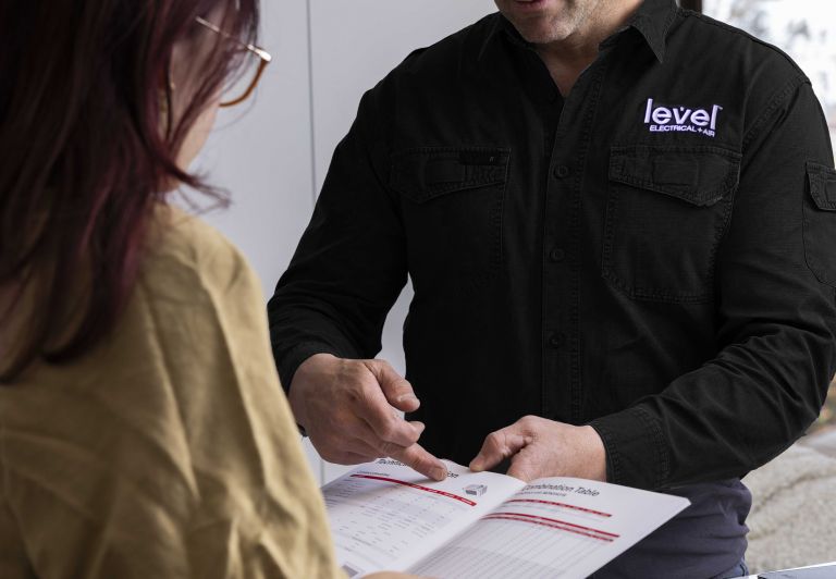 level electrical + air hvac technician guiding customer through a new product installation
