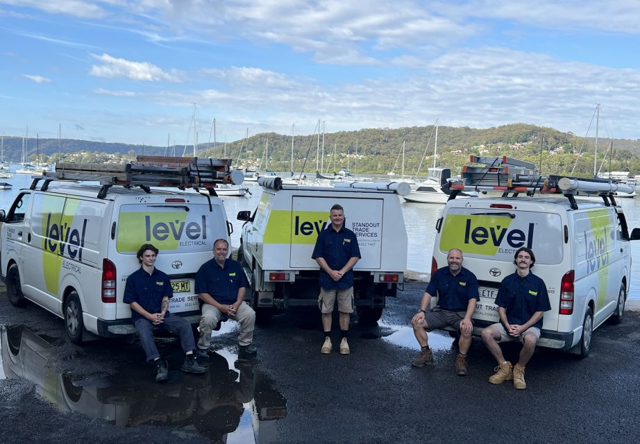 Level Electrical & Air West Gosford electricians with branded service vehicles, providing electrical services across the Central Coast.