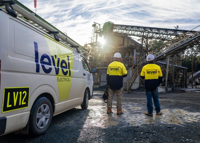 Level Electrical Taree team onsite at the Possum Brush hard rock crushing plant, standing beside a branded service vehicle during the MCC and automation upgrade.