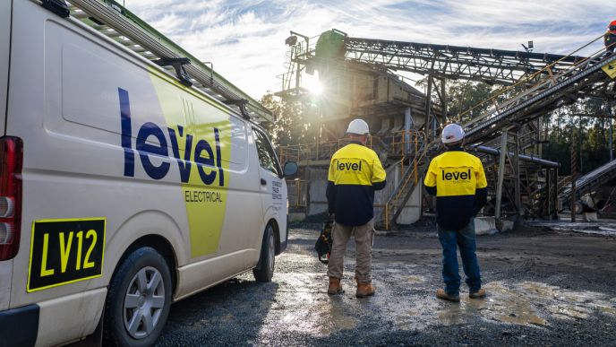 Level Electrical Taree team onsite at the Possum Brush hard rock crushing plant, standing beside a branded service vehicle during the MCC and automation upgrade.