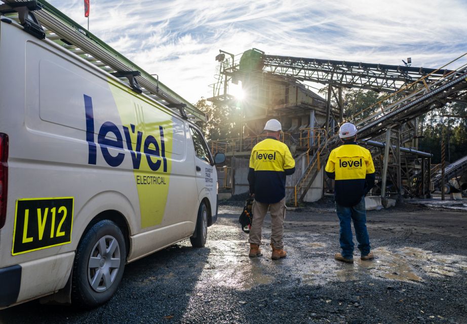 Level Electrical Taree team onsite at the Possum Brush hard rock crushing plant, standing beside a branded service vehicle during the MCC and automation upgrade.