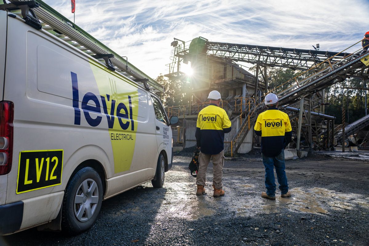 Level Electrical Taree team onsite at the Possum Brush hard rock crushing plant, standing beside a branded service vehicle during the MCC and automation upgrade.