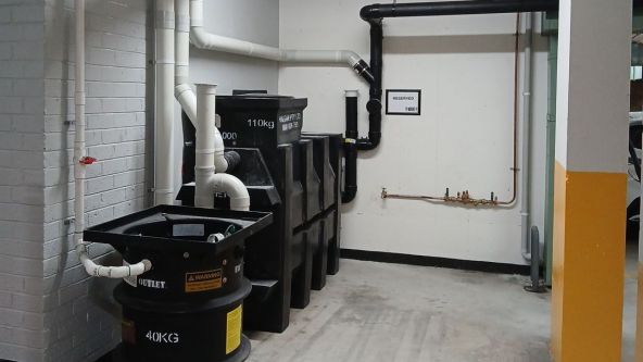 a commercial setup showcasing a black grease trap installed by level plumbing commercial division