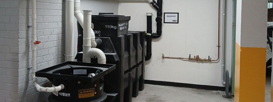 a commercial setup showcasing a black grease trap installed by level plumbing commercial division