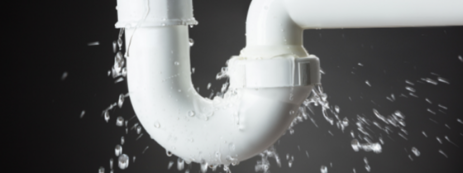 a white under-sink pipe leaking water