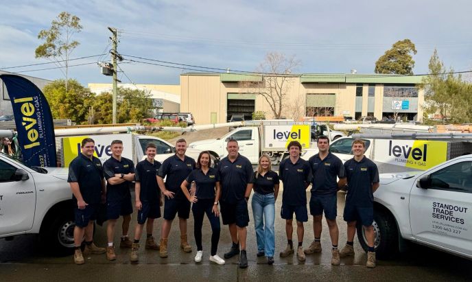 Level Plumbing and Gas Newcastle Central team standing in front of newly branded Level vehicles.