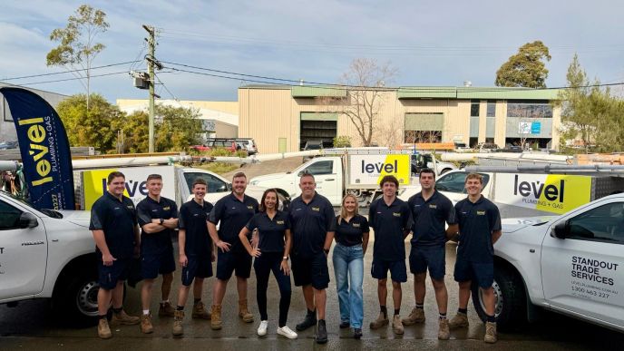 Level Plumbing and Gas Newcastle Central team standing in front of newly branded Level vehicles.
