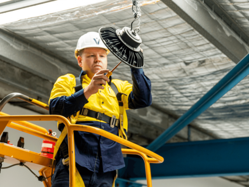 Level Electrician installing a commercial light in Sydney CBD