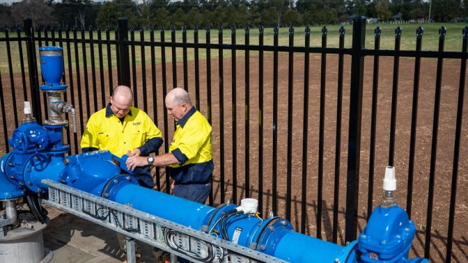 Level plumbers inspecting and repairing large commercial water pipeline system in Australia