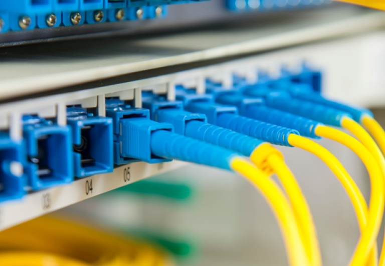 Fibre data cables connected to a network patch panel for structured cabling and network infrastructure