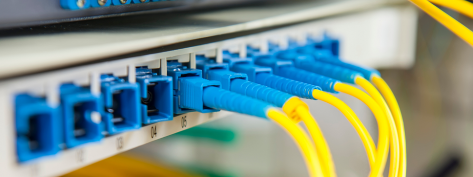 Fibre data cables connected to a network patch panel for structured cabling and network infrastructure