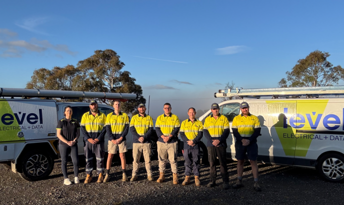 Level Electrical & Data Goulburn team standing in front of fully branded Level Electrical + Data vehicles in Goulburn.