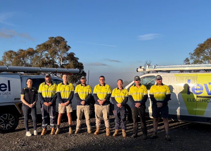 Level Electrical & Data Goulburn team standing in front of fully branded Level Electrical + Data vehicles in Goulburn.