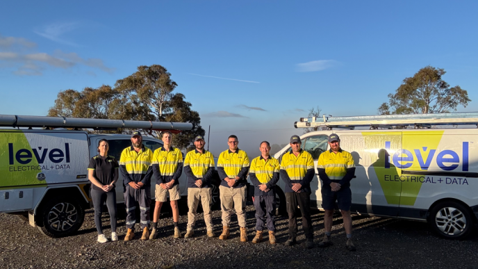Level Electrical & Data Goulburn team standing in front of fully branded Level Electrical + Data vehicles in Goulburn.