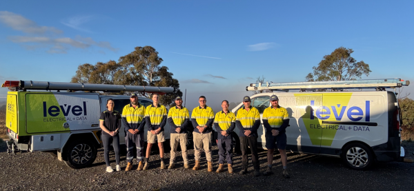 Level Electrical &amp;amp; Data Goulburn team standing in front of fully branded Level Electrical + Data vehicles in Goulburn.