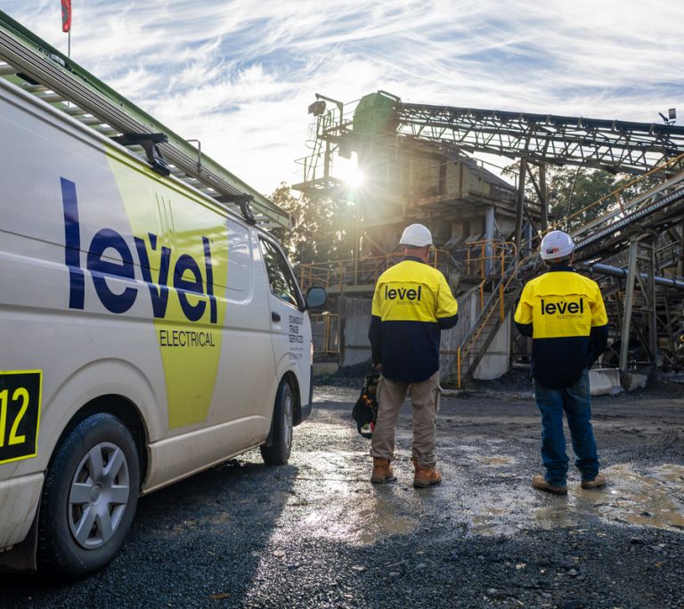 Level Electrical technicians arriving at an infrastructure project site beside a Level service vehicle in Australia