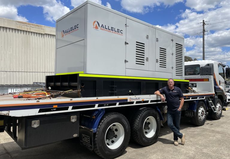 Allelec Services Australia generator being transported on a truck for a commercial electrical project in Sydney.