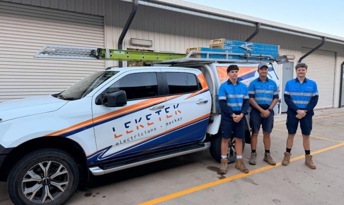 Three members of the Leketek team beside their branded electrical work vehicle in Mackay.