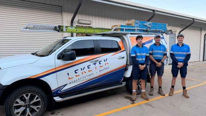Three members of the Leketek team beside their branded electrical work vehicle in Mackay.