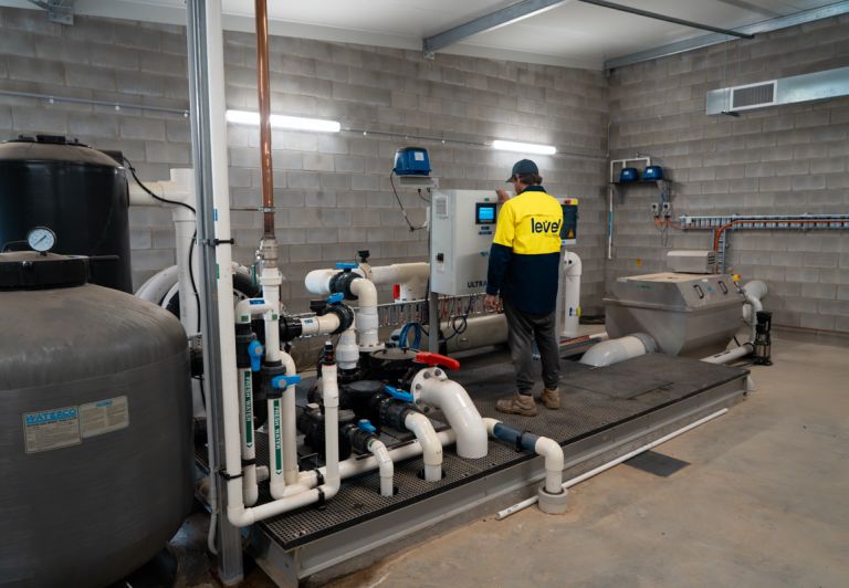Level plumber inspecting and maintaining commercial water infrastructure and pipe systems in Australia