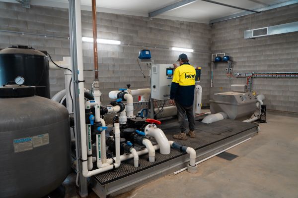Level plumber inspecting and maintaining commercial water infrastructure and pipe systems in Australia