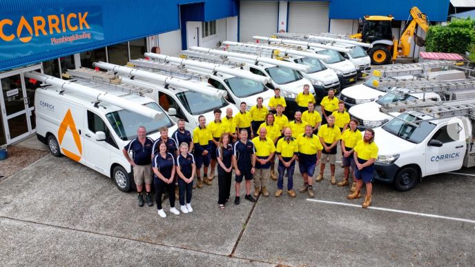 Carrick Plumbing & Roofing team with service vehicles at their Port Macquarie headquarters, part of Level Group Australia