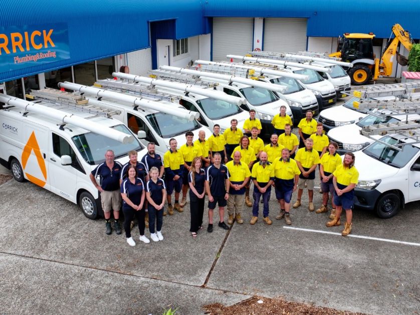Carrick Plumbing & Roofing team with service vehicles at their Port Macquarie headquarters, part of Level Group Australia
