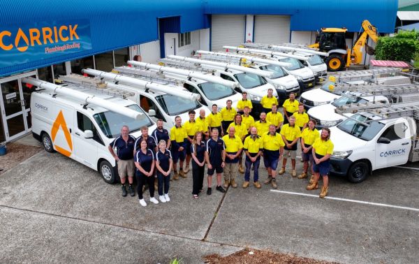 Carrick Plumbing &amp;amp;amp;amp; Roofing team with service vehicles at their Port Macquarie headquarters, part of Level Group Australia