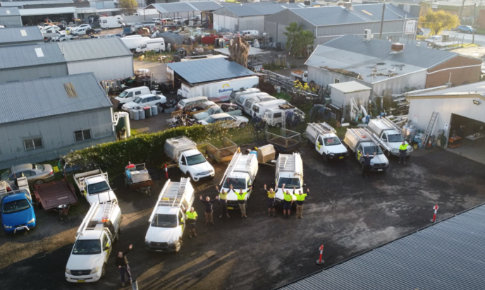 The Level Plumbing Tamworth team with their fleet of vehicles outside the Tamworth office.