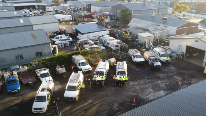 The Level Plumbing Tamworth team with their fleet of vehicles outside the Tamworth office.