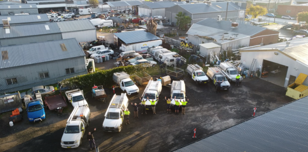 The Level Plumbing Tamworth team with their fleet of vehicles outside the Tamworth office.