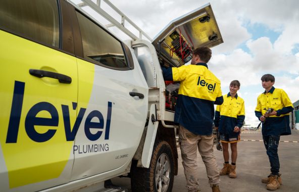 Level plumbing technicians accessing equipment from a service truck on site in Australia