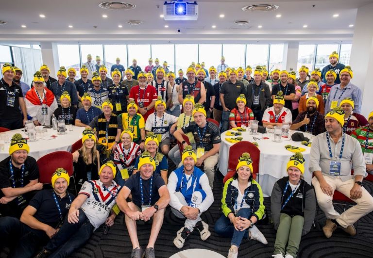 Level Members at the Next Level Conference Hobart 2023 wearing team colours and Level beanies on AFL and NRL grand final weekend