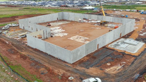 High aerial view of concrete panel wall installation and civil hydraulic ground preparation for The Village Southlakes commercial retail development in Dubbo.