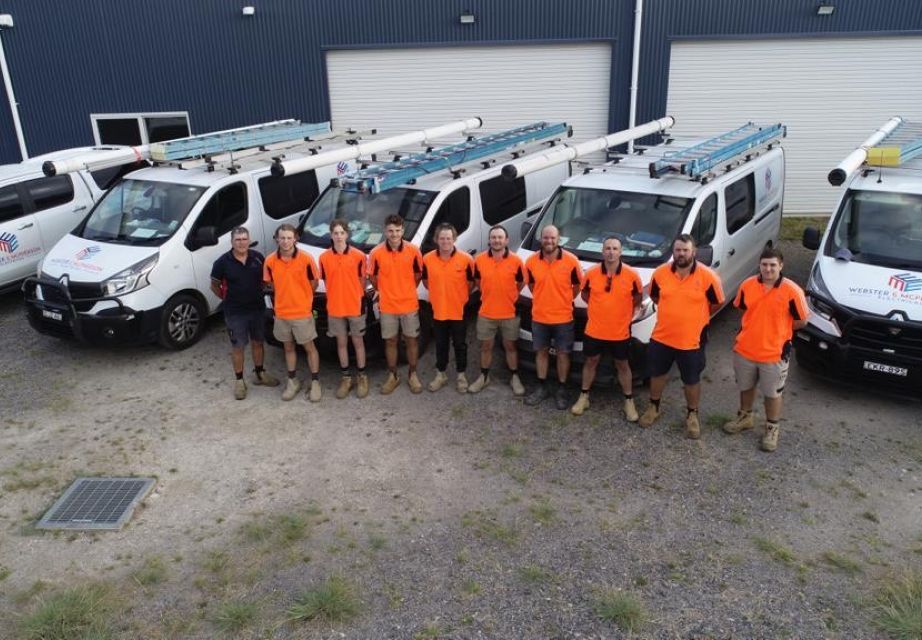 Webster & McPherson Electrical team standing in front of branded service vehicles before rebranding to Level Electrical & Data Goulburn.