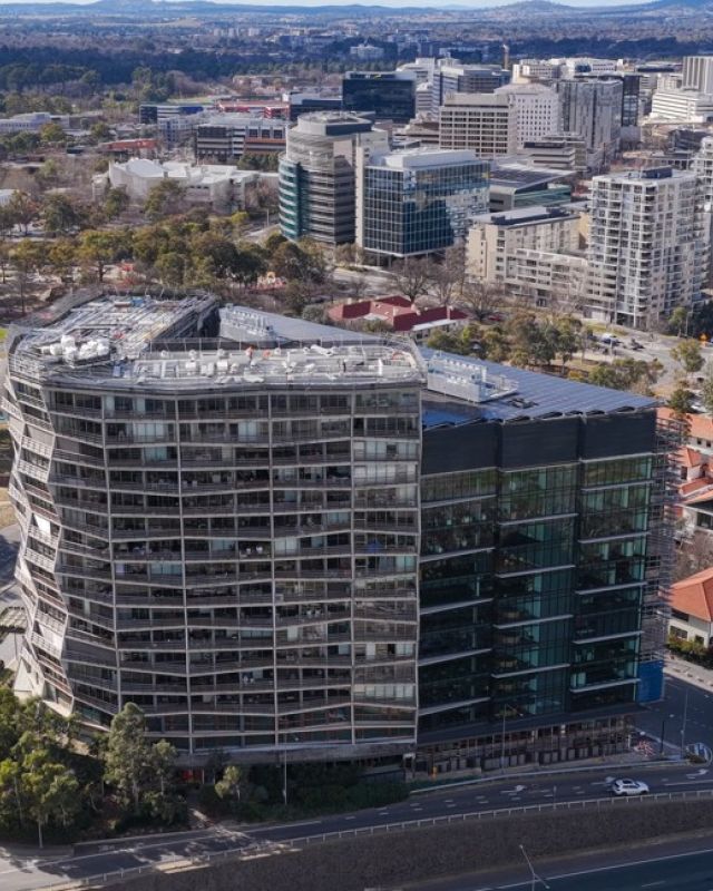 Aerial view of the award-winning Nishi Building in Canberra, featuring Level Plumbing Canberra’s work delivering complex hydraulic and plumbing systems for a large-scale sustainable development.