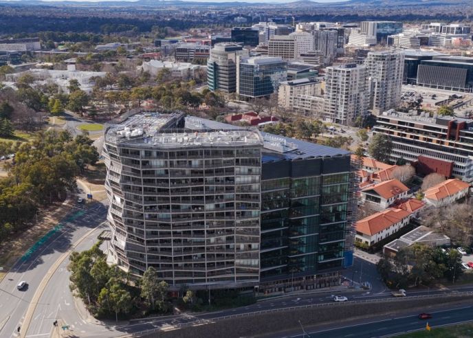 Aerial view of the award-winning Nishi Building in Canberra, featuring Level Plumbing Canberra’s work delivering complex hydraulic and plumbing systems for a large-scale sustainable development.