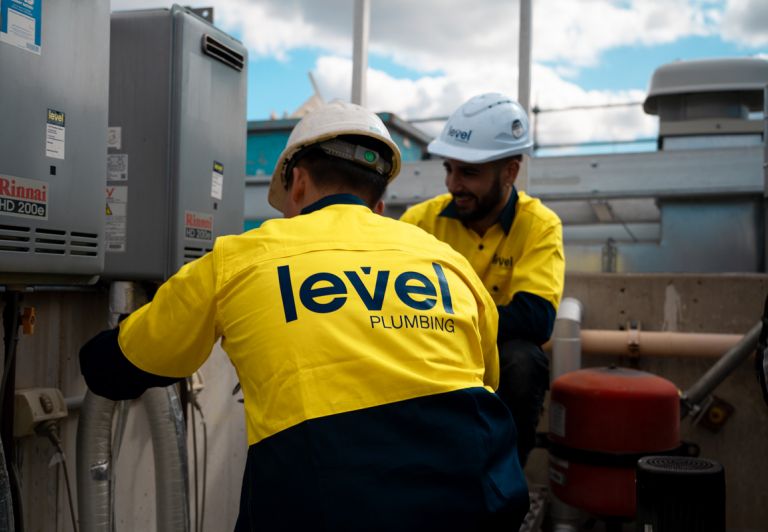 Level Plumbing Canberra technicians servicing commercial hot water systems, delivering reliable maintenance solutions across the ACT.