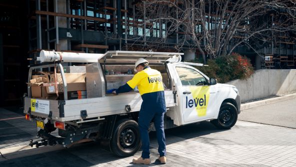 Level Plumbing Canberra technician loading tools from service vehicle at the Nishi Building commercial project in Canberra