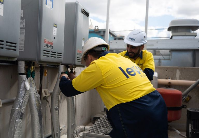 Level Plumbing Canberra technicians performing professional gas fitting installation and maintenance on commercial hot water systems