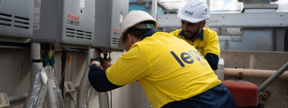 Level Plumbing Canberra technicians performing professional gas fitting installation and maintenance on commercial hot water systems