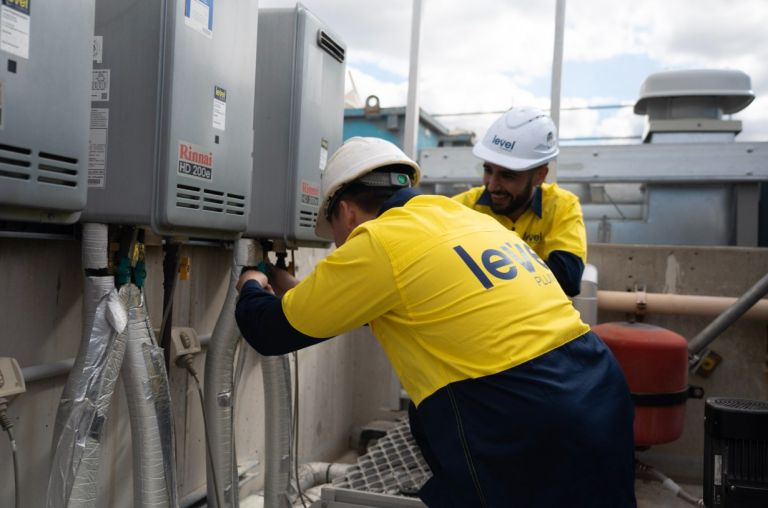 Level Plumbing Canberra technicians performing professional gas fitting installation and maintenance on commercial hot water systems