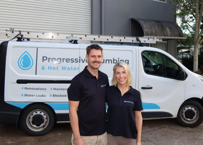 Jimmi Keller and Amelia from Level Plumbing Kunda Park standing in front of a Progressive Plumbing & Hot Water vehicle on the Sunshine Coast.
