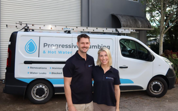 Jimmi Keller and Amelia from Level Plumbing Kunda Park standing in front of a Progressive Plumbing & Hot Water vehicle on the Sunshine Coast.